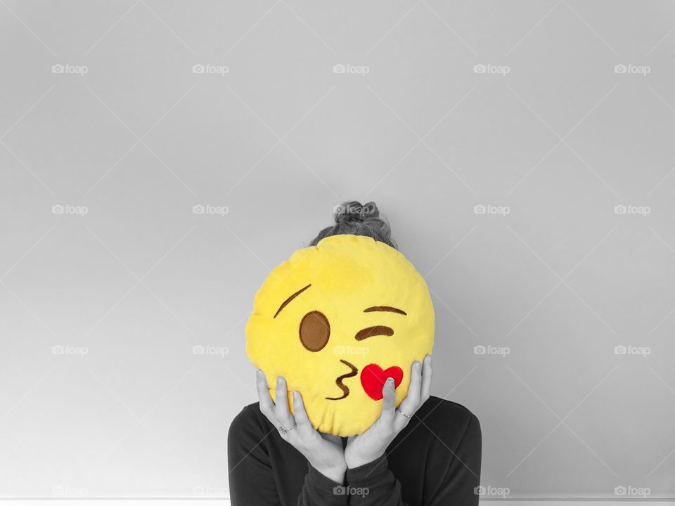 Girl with emoji pillow