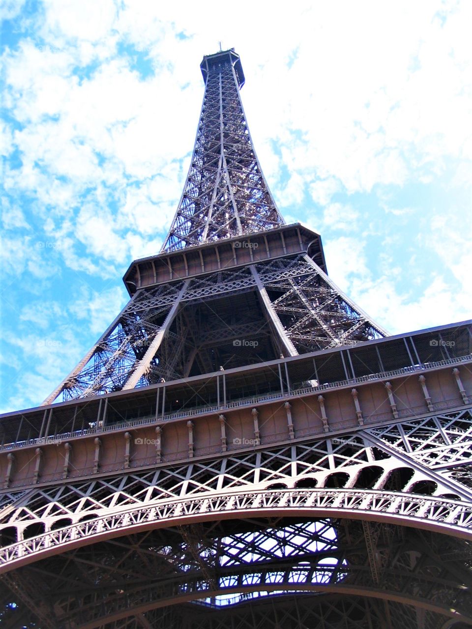 Mighty Eiffel Tower with the clouds in a background. 

Number One Must See Place in Paris!