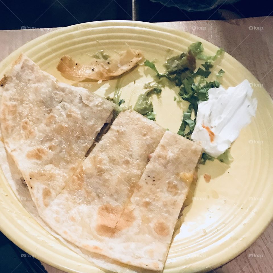 A delicious plate of of a cheese and steak burrito served at a restaurant located in America, USA. 