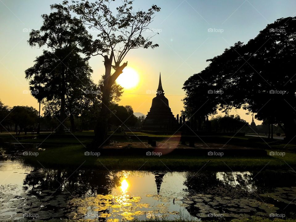 Setting sun over temple Thailand 