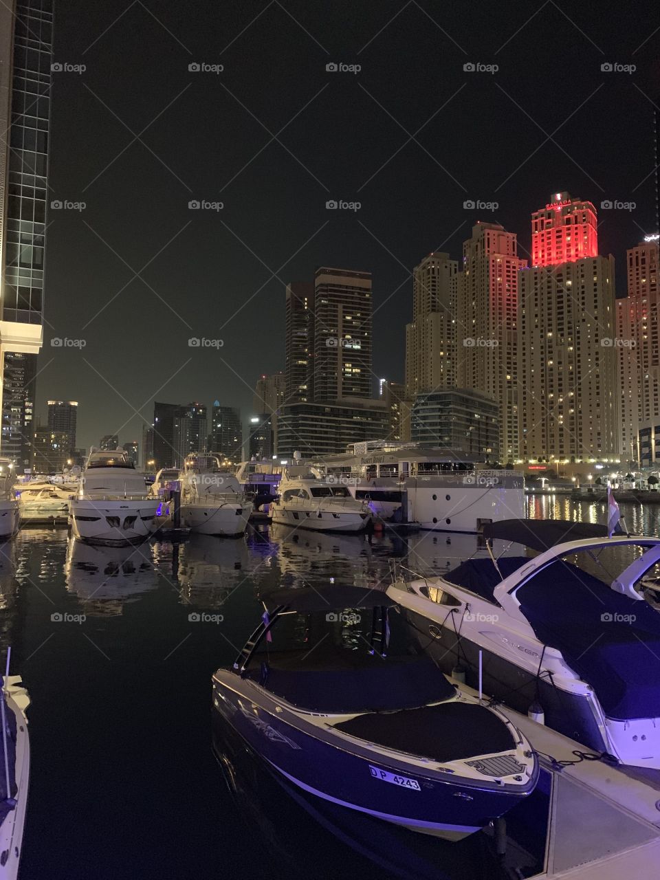 The best background for white is always night. The most bright light you can see at night. Expensive and сhic Dubai Marina promenade.