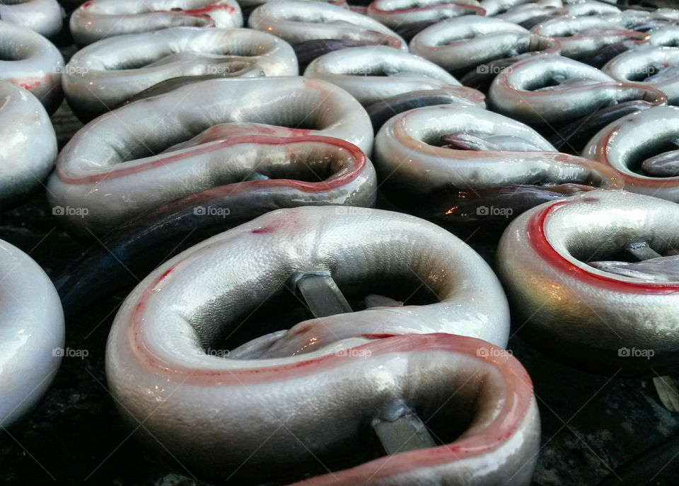 close up of skewered eels ready to bbq