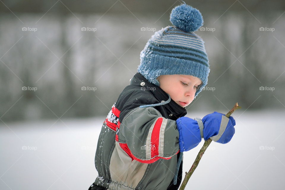 Toddler playing outdoors in the snow