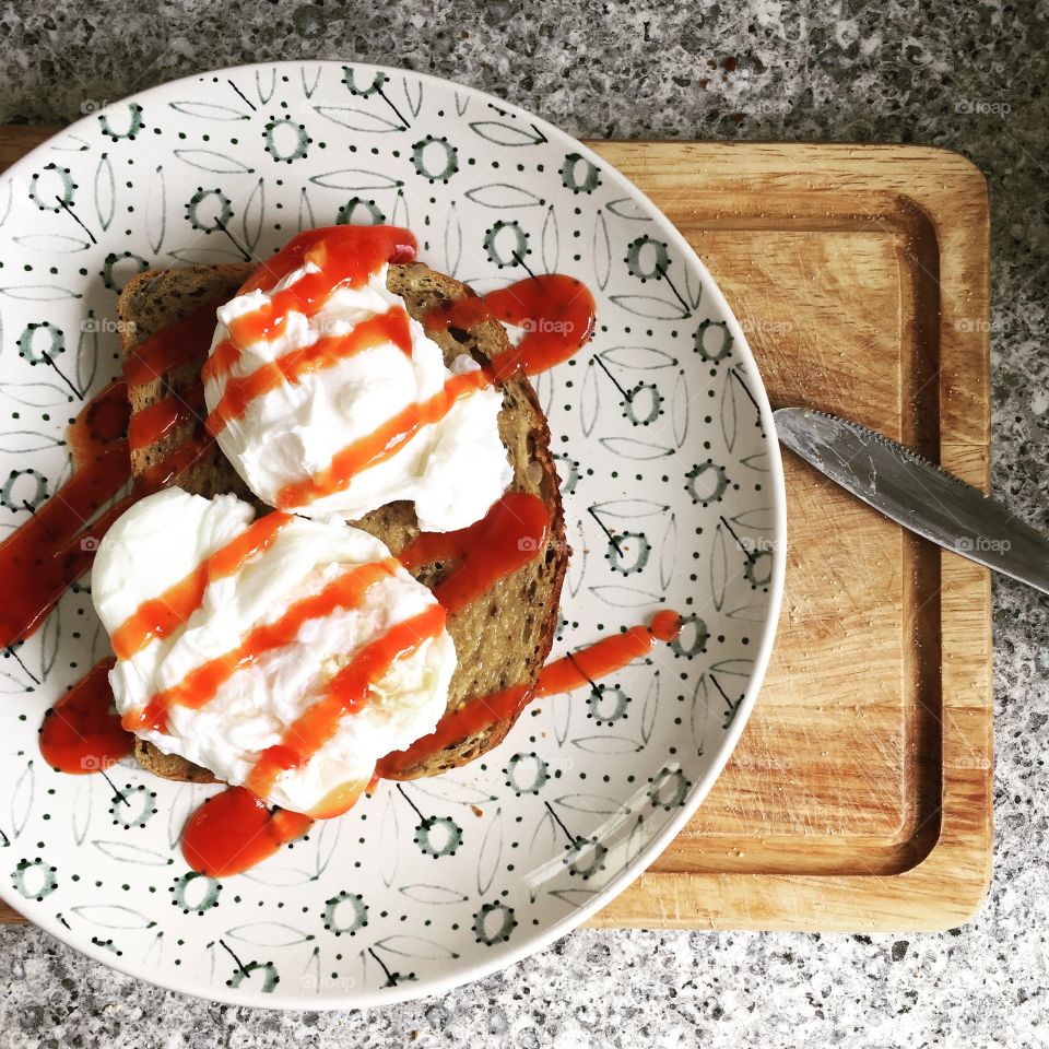 Poached eggs on toast with seeded bread and ketchup