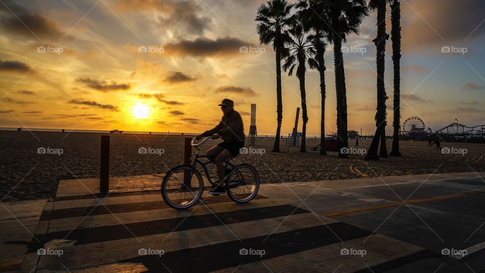 Biking at beach during sunset 