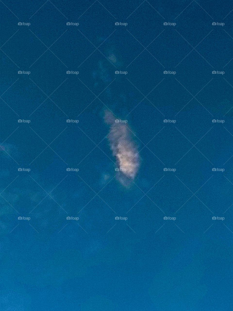 White clouds in the sky.  And dark clouds.  The sky is blue.  It is a very beautiful picture.