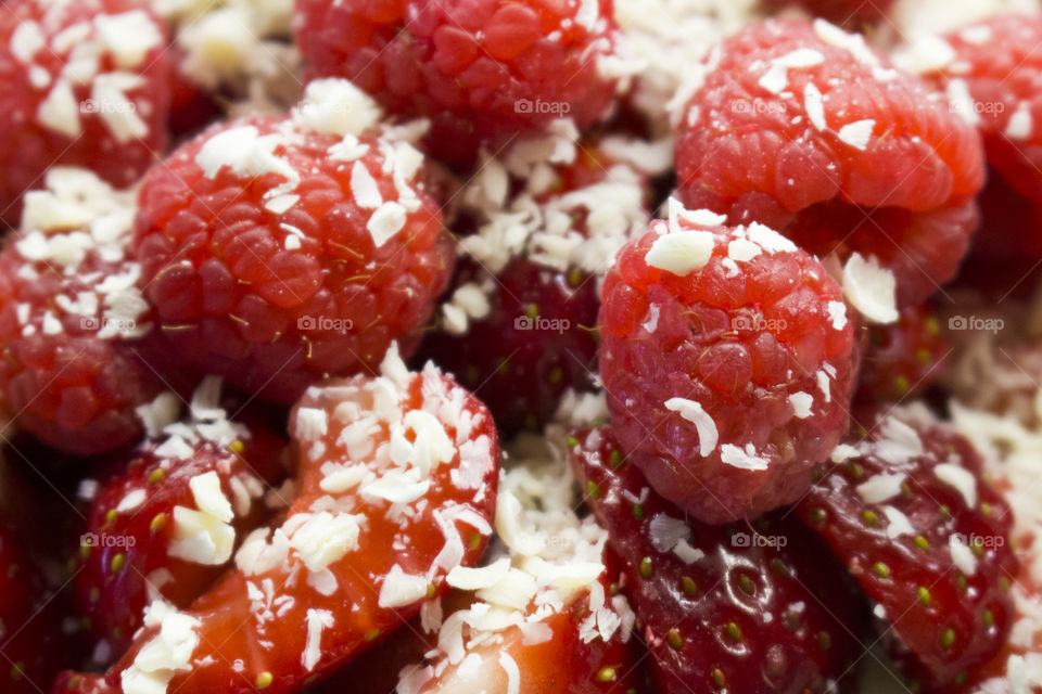 Raspberries strawberries with white grated chocolate 