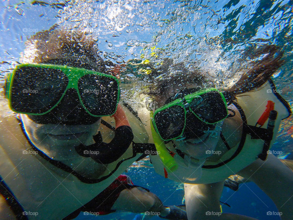 Couple with mask snorkeling in sea