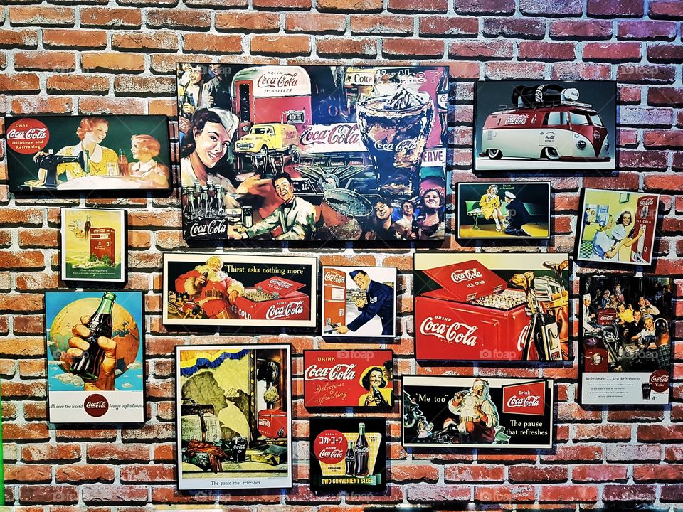 vintage Coca cola poster metallic plaque decoration hanging on a brick wall