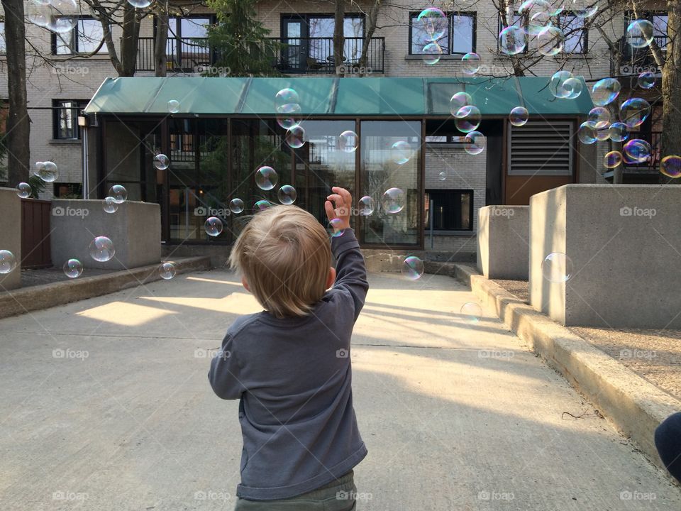 Child playing with soap bubbles