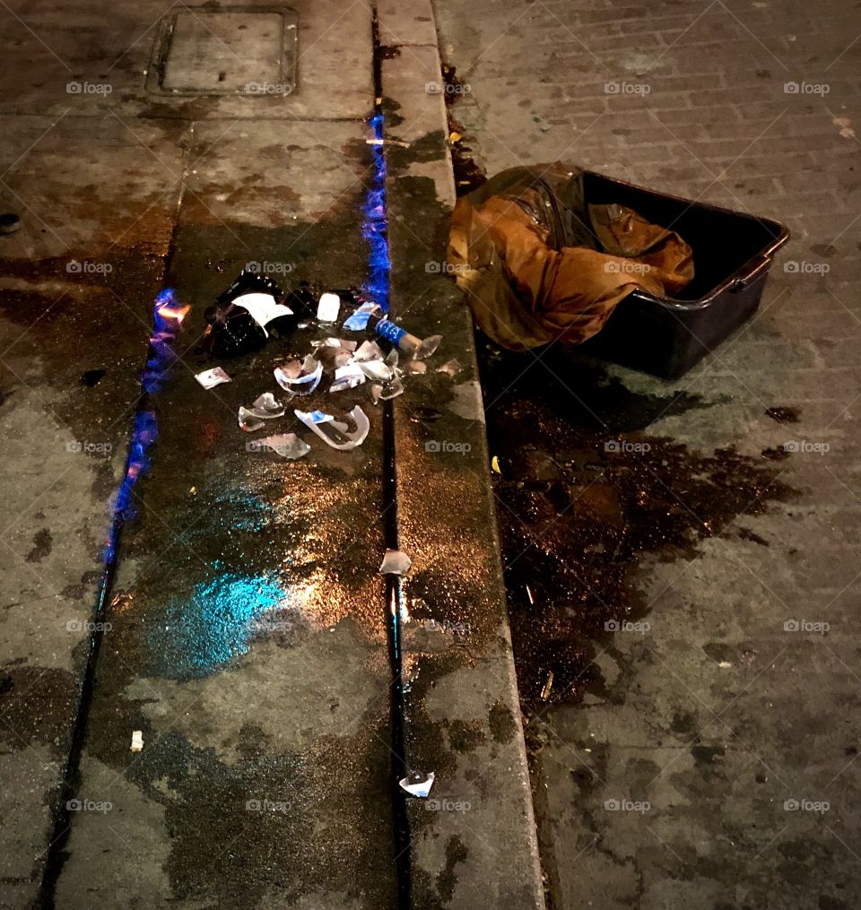 Alcohol spilled from broken bottles burns in 2 rows of flame on a dirty gritty sidewalk in Downtown Los Angeles 6.10.2020