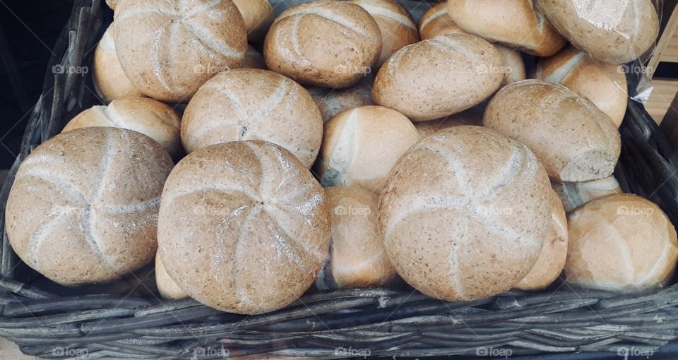 At the bakery: A basket full of freshly bakes buns. Perfect breakfast material! In Germany, they call these Kaiser Brötchen.