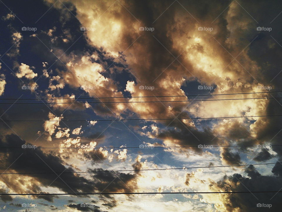 Sunset and powerlines . clouded sunset behind powerlines 