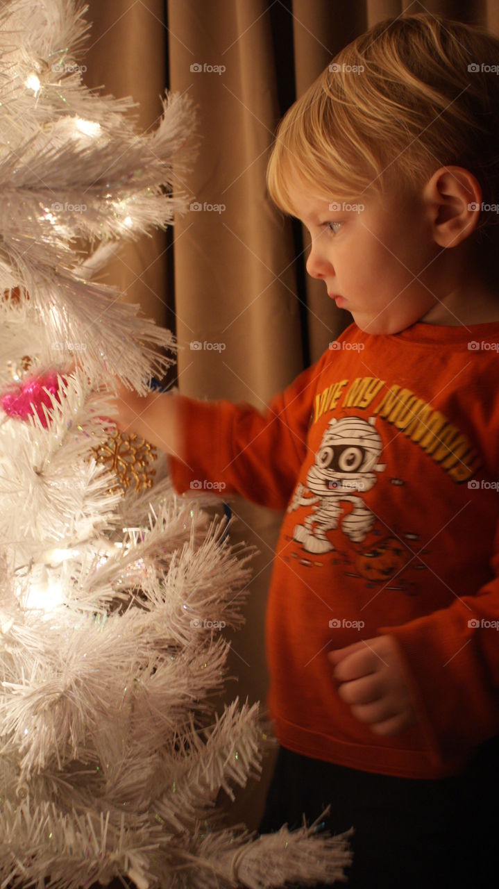 Decorating the tree with mason hanging ornaments 