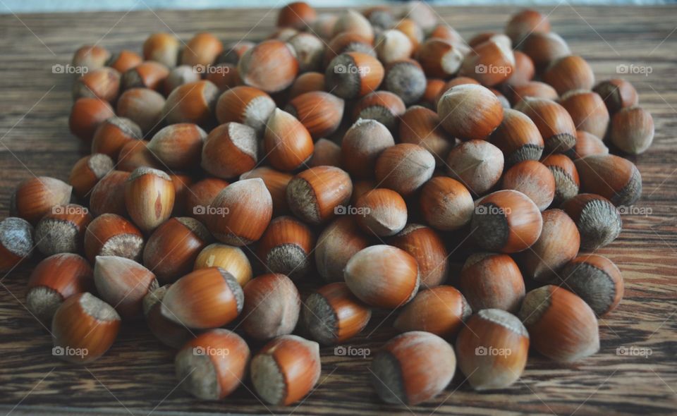 Closeup of hazelnuts on wooden background