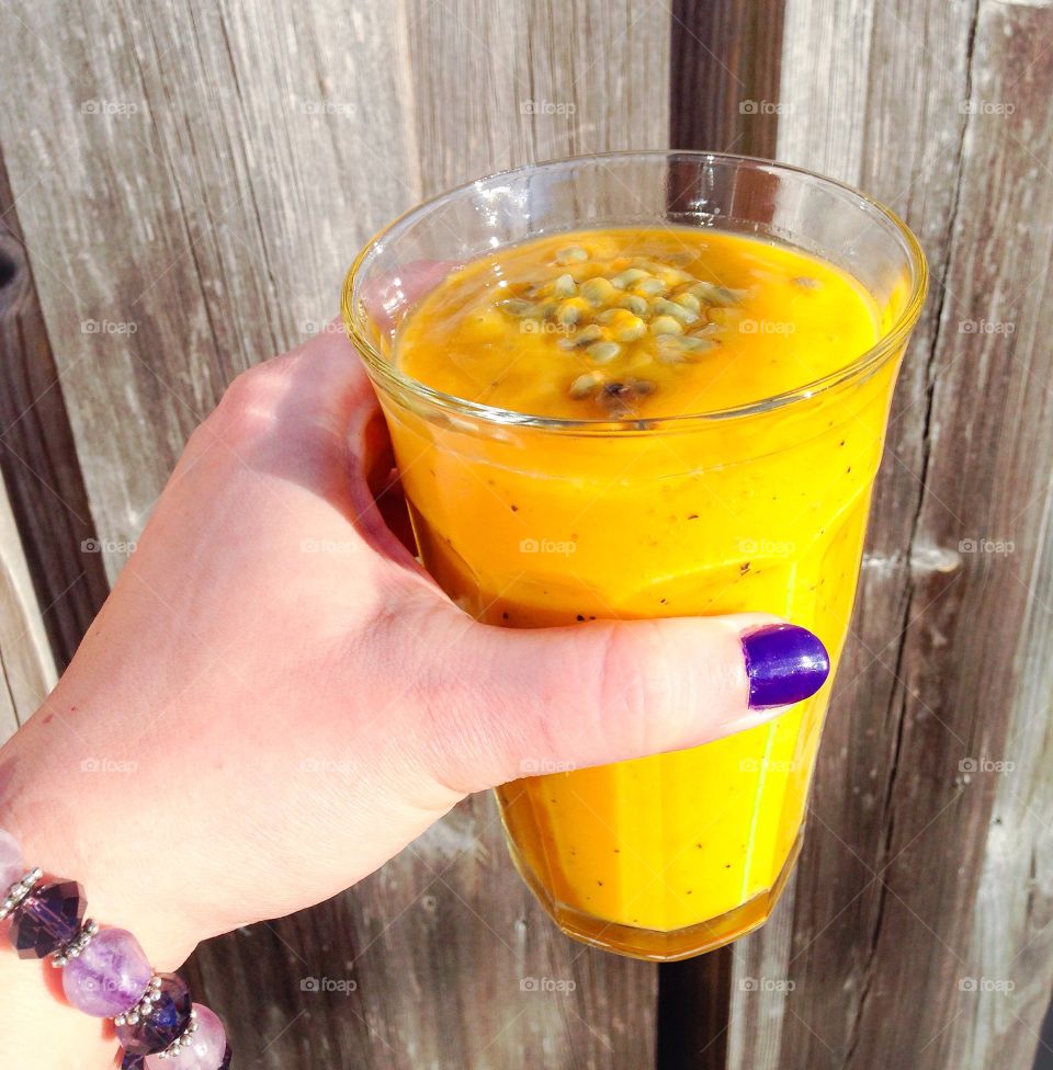 Woman's hand holding smoothie