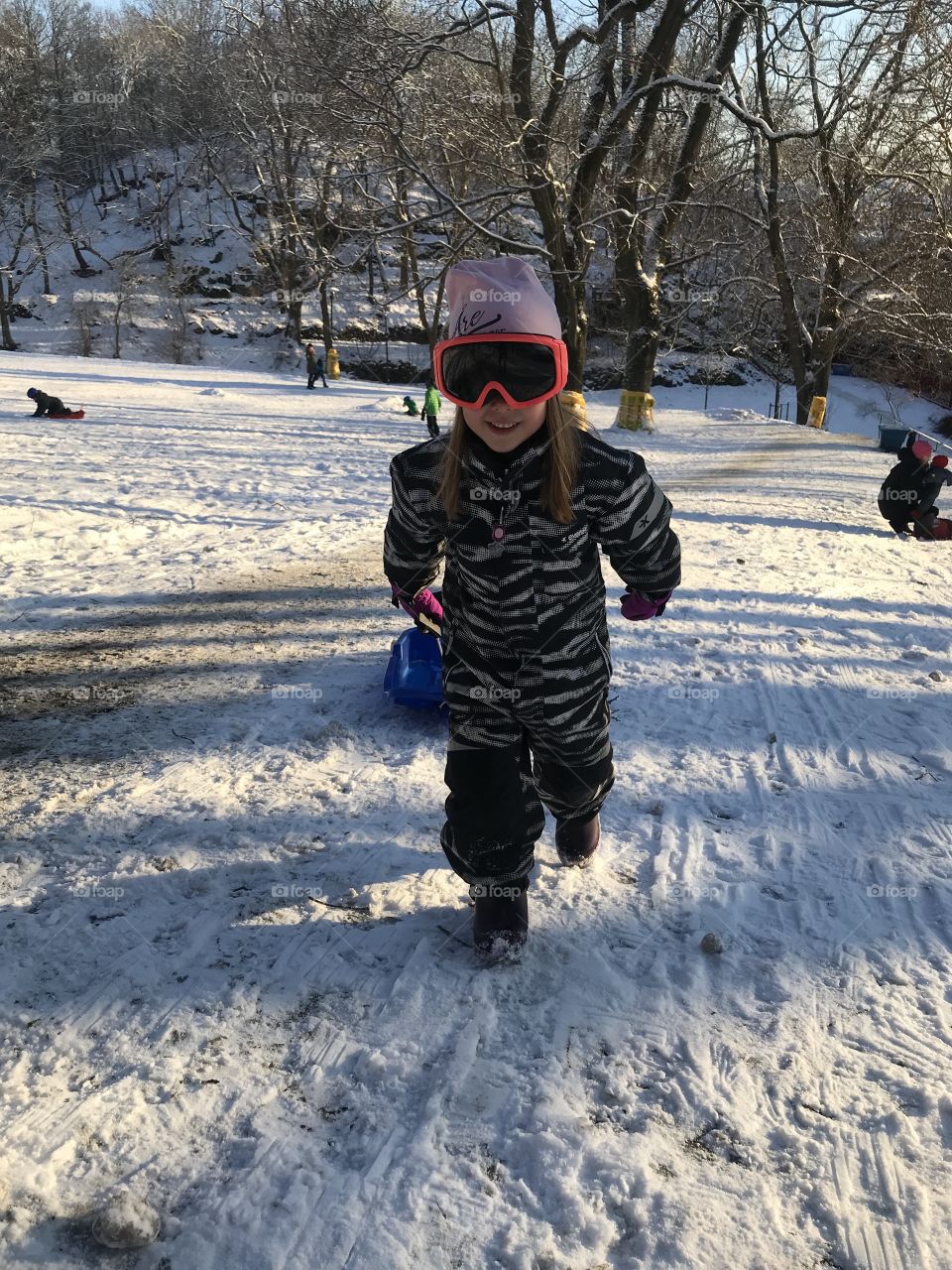 Kid having fun in snowy hill