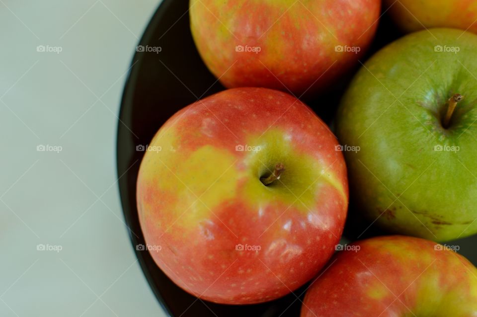 Red apple on the black dish