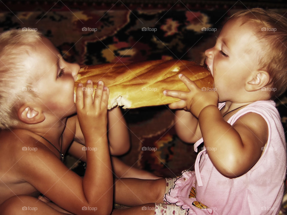 Children eating a fresh baked bun. Who is fastest?