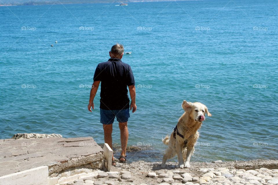 Dog and owner having fun on seafront