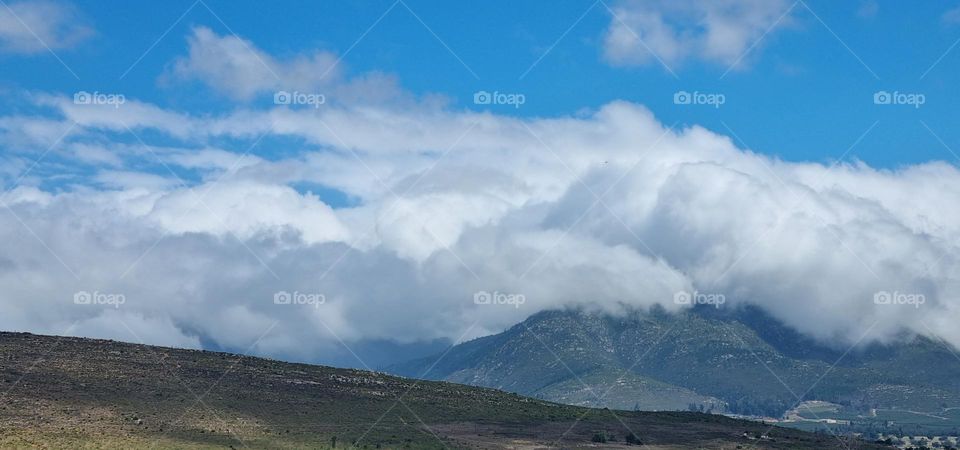 clouds rolling over the mountains.