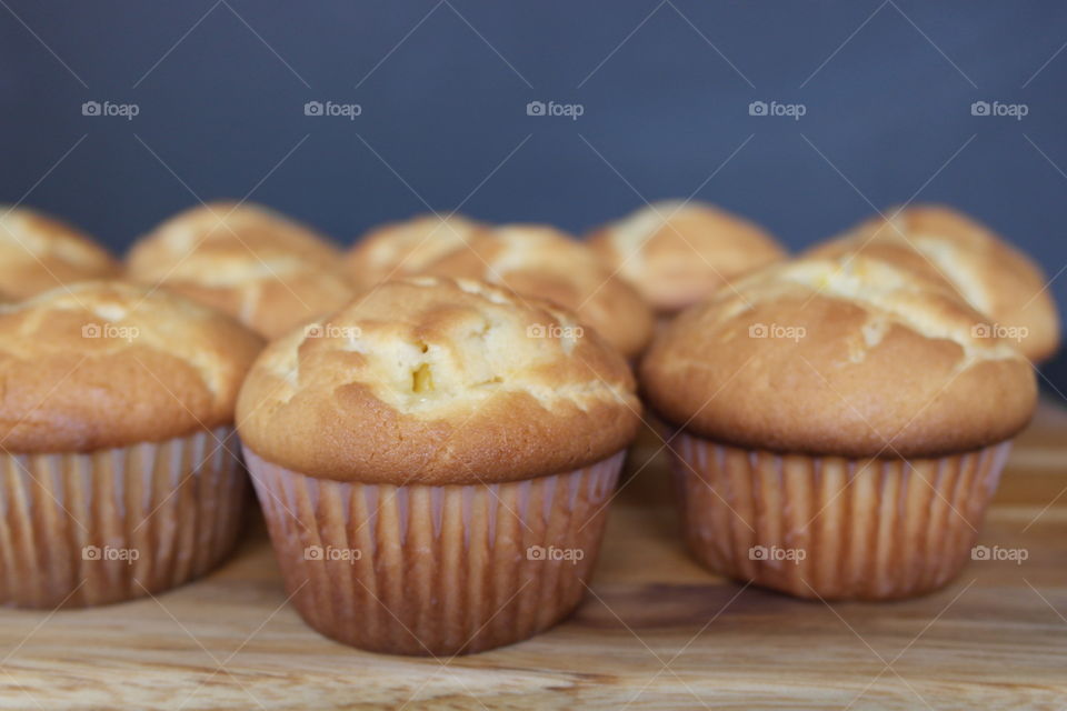 Peach cupcakes on a wooden board