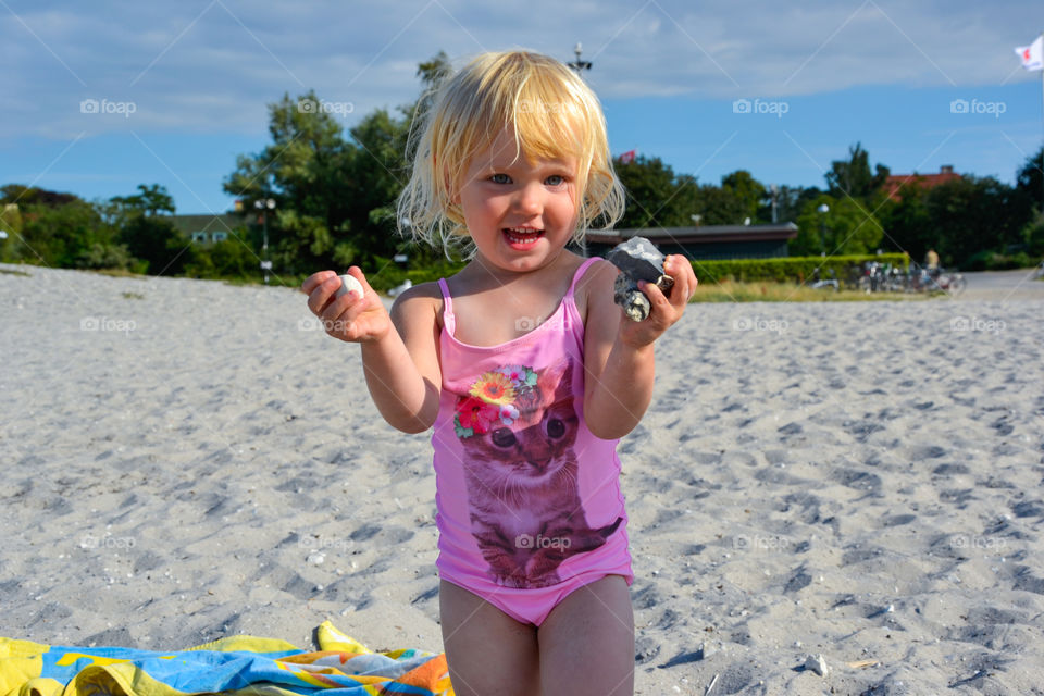 Little girl playing on the beach Ribban in Malmö Sweden.
