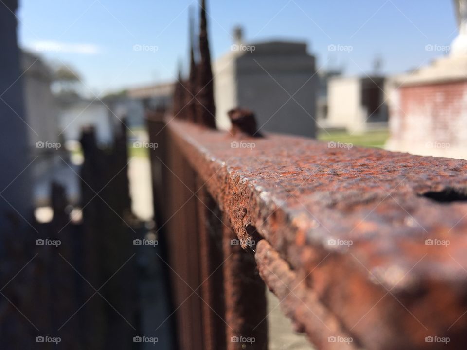 Just a rusted fence in a cemetery 