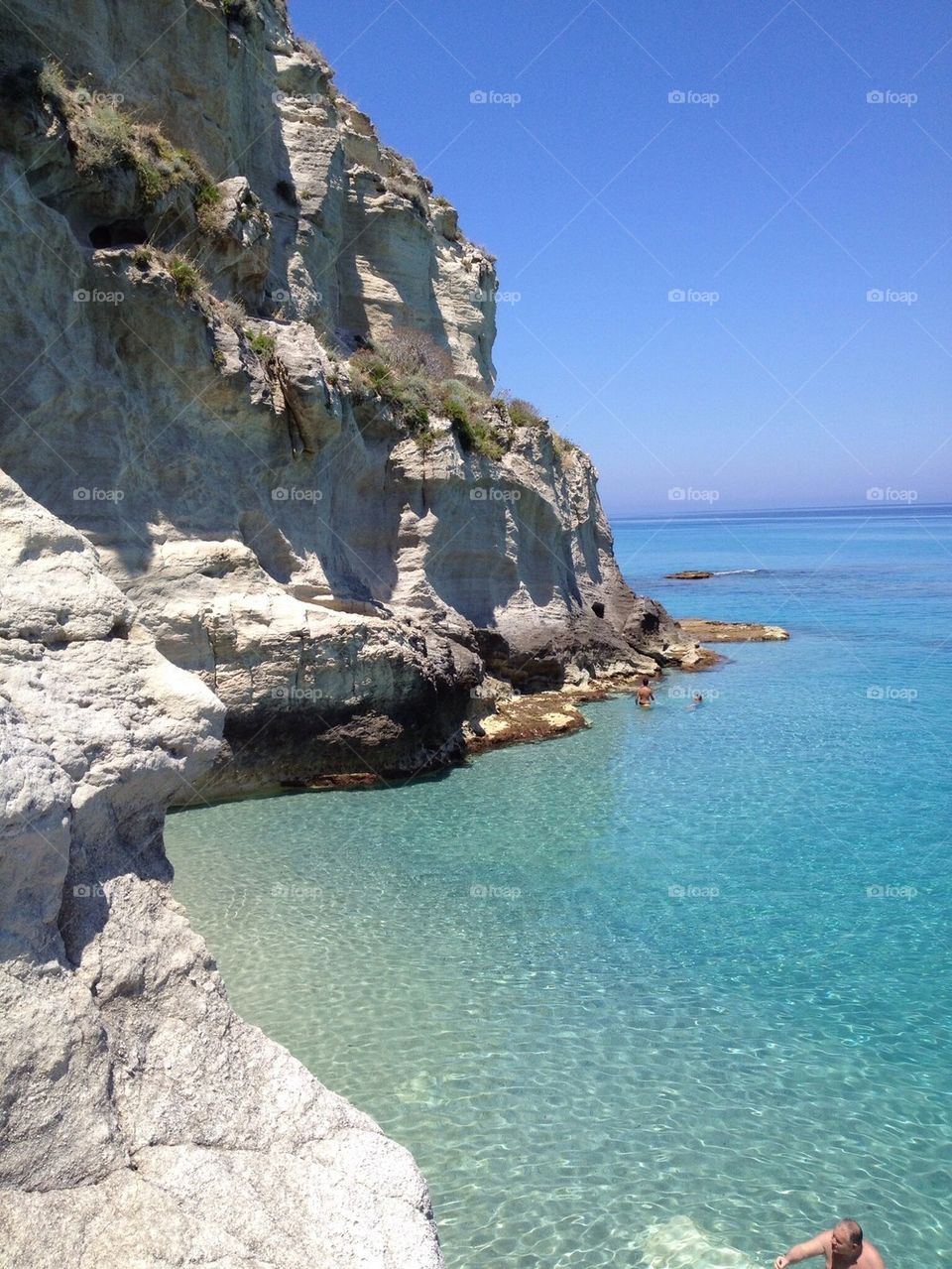 View of cliff against blue sky