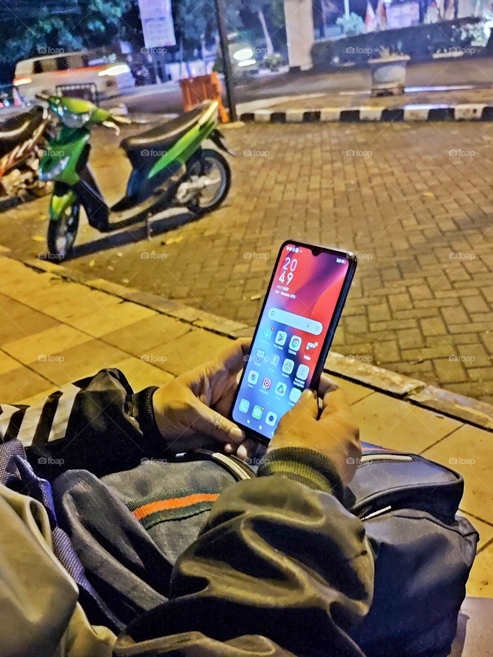 Someone with smartphone at night