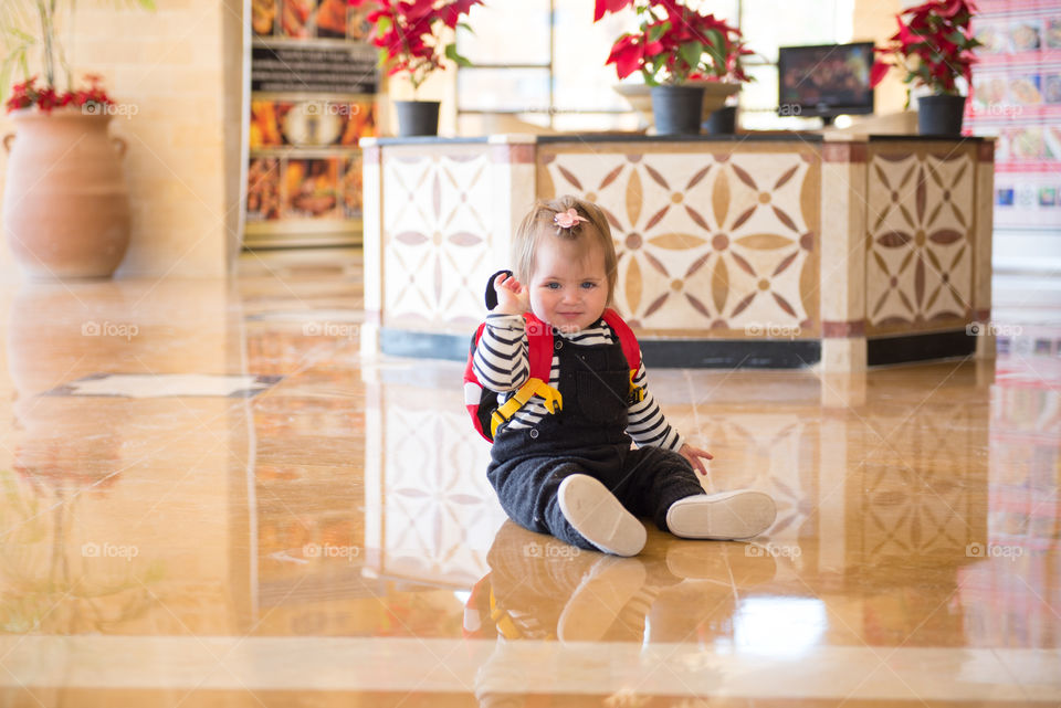 Baby girl sitting on floor