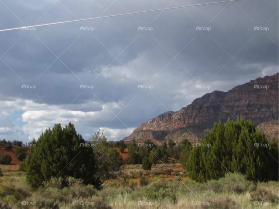 Scenic view of mountain against storm cloud