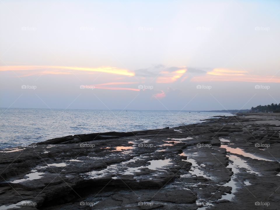 Sea shore rock and sun set