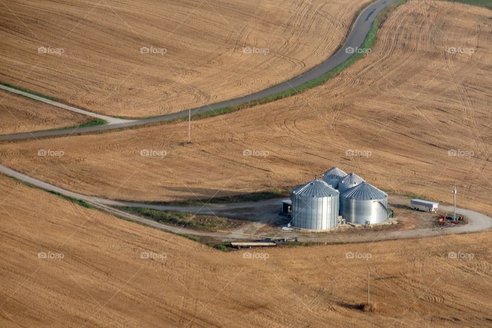 Foap, Roads of the USA: Aerial view of a country road dividing golden harvested fields in Cowan, Tennessee. 
