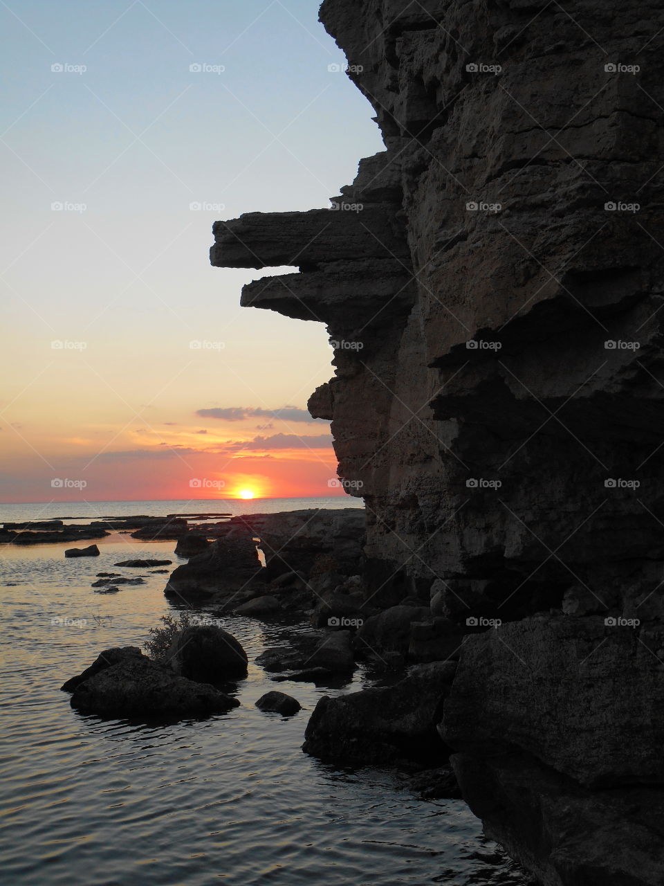 stone face on a sunset sea beautiful summer seascape art nature