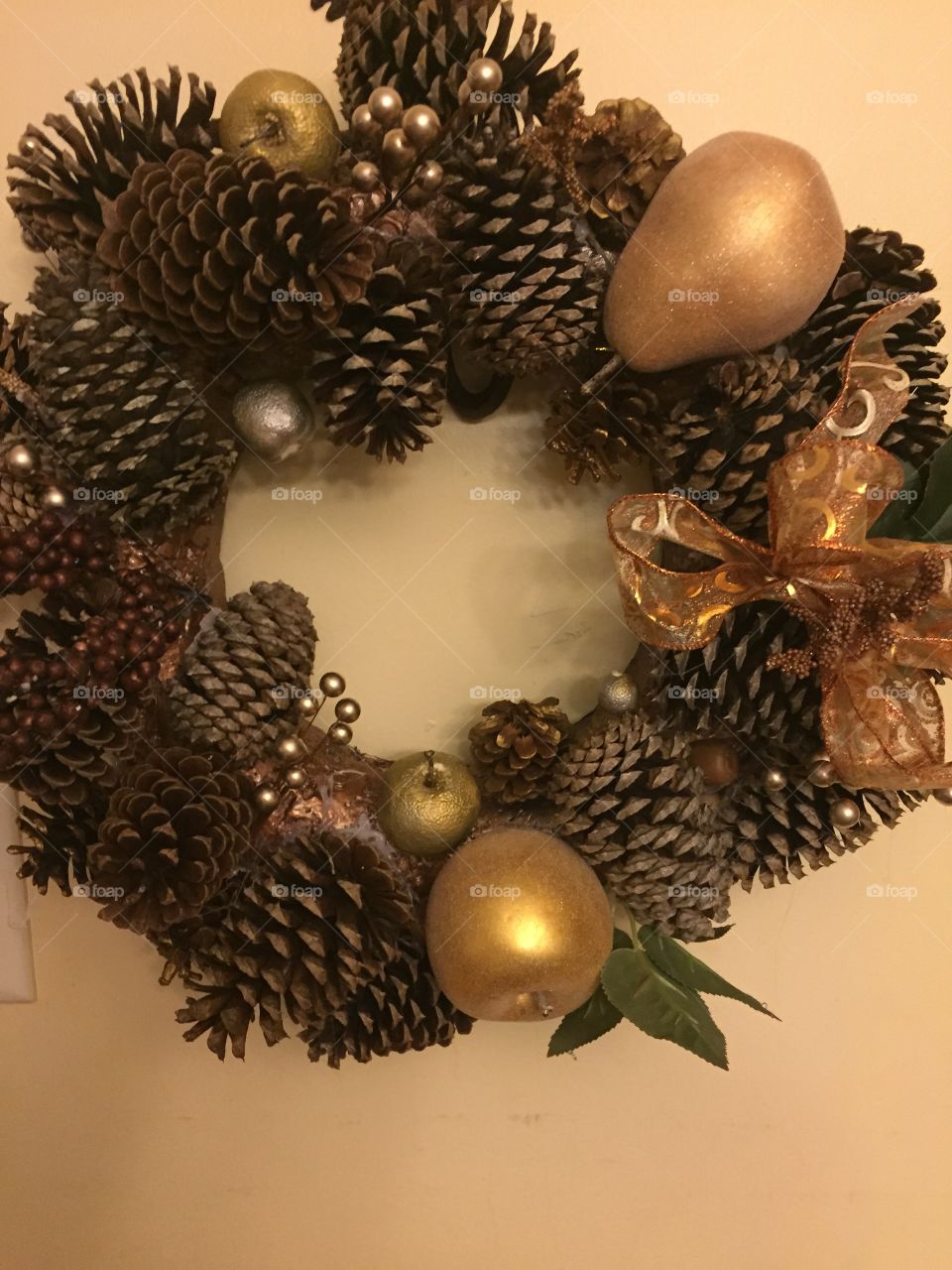 Pinecone wreathe with gold apples and pear, and beautiful now.