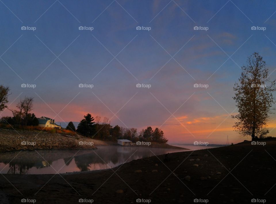 Sunrise on a misty shoreline