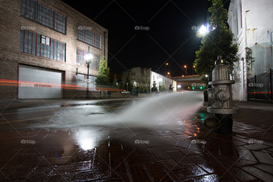 Fire hydrant with water on the ground 