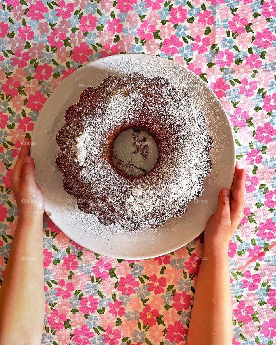 Mobile series: Little girl hands holding homemade cake