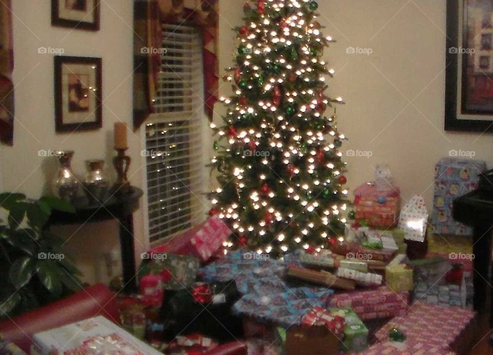 Lit Christmas tree with presents