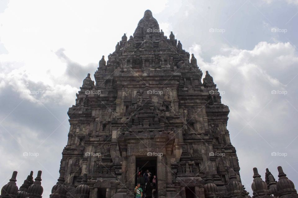 One of the temples in the Prambanan Temple Complex, with a stone relief on the wall of the temple which is part of the largest Hindu temple in Southeast Asia, Yogyakarta, Indonesia - June 23, 2023