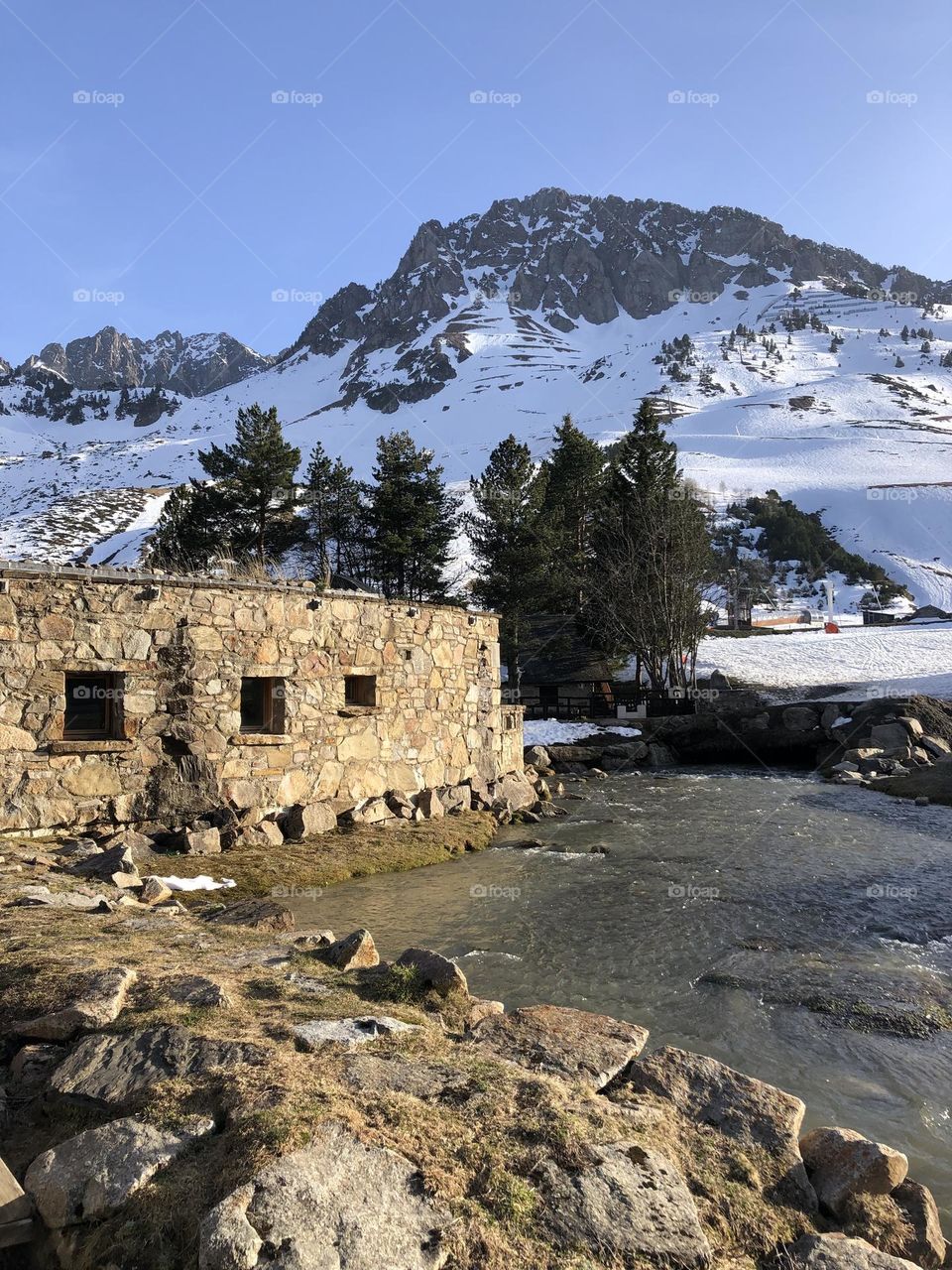 Mountain covered by snow and the building made of stone