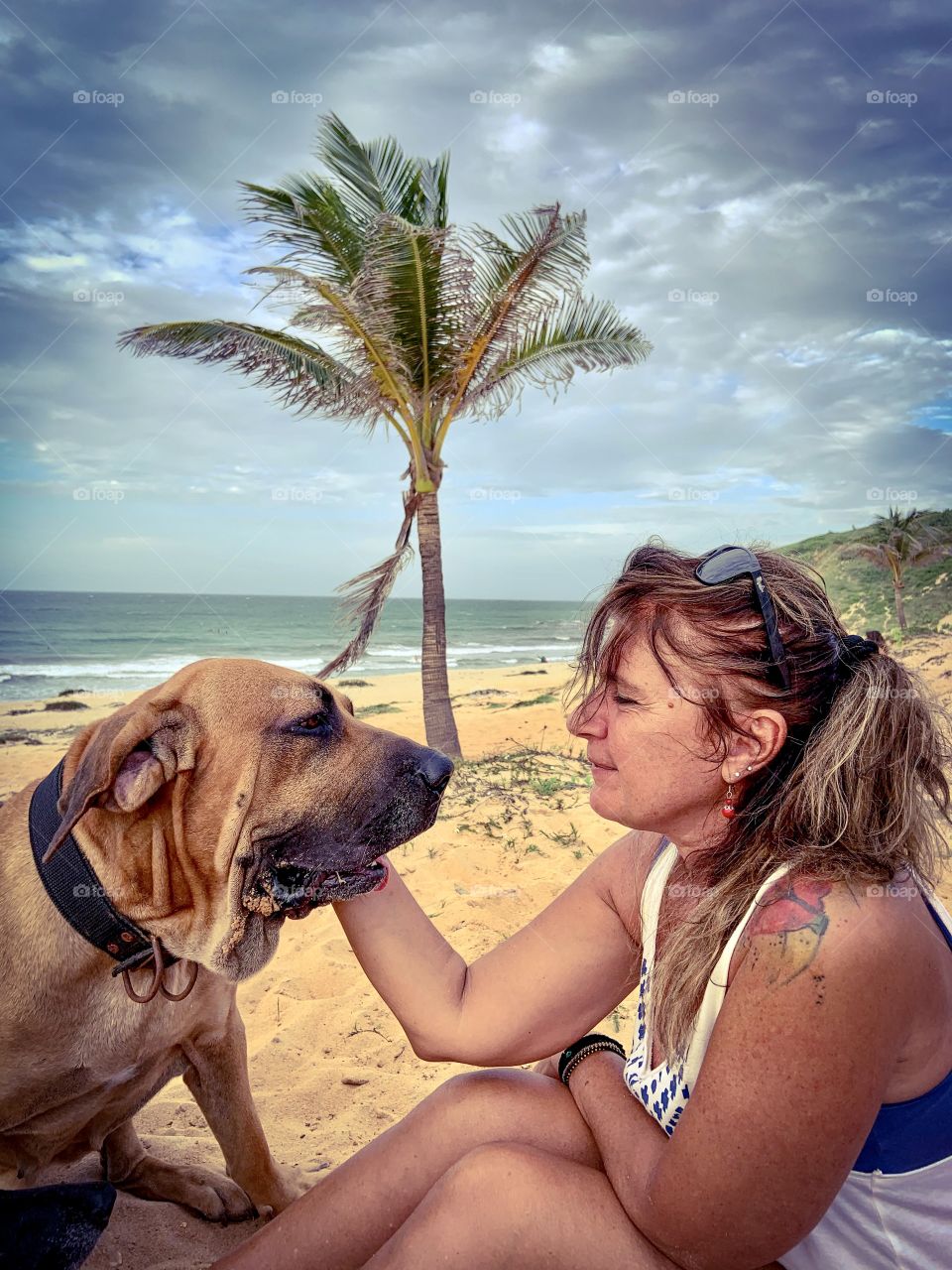 Woman and dog in the beach 
