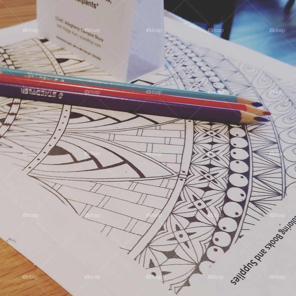 coloring pages and colored pencils set out for coffee shop patrons