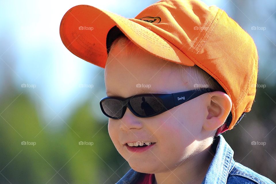 Cute boy in cap and sunglasses