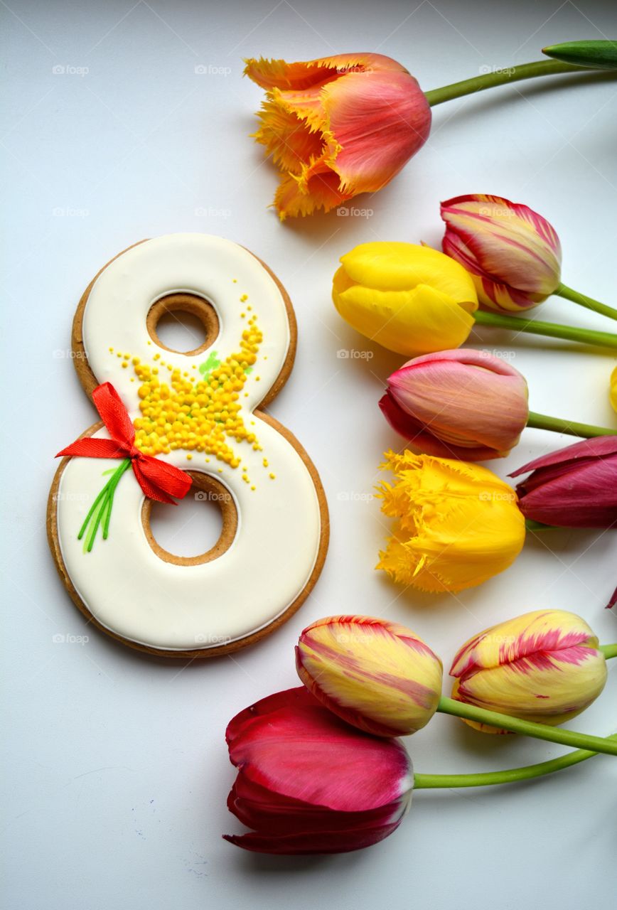 8 March gingerbread and colorful tulips on a white background women's day