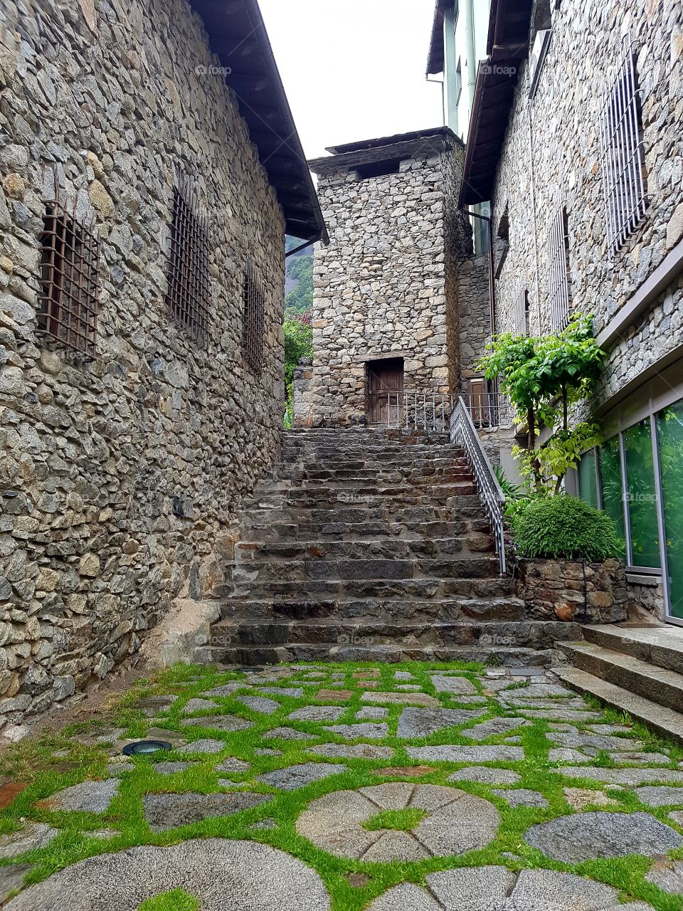 stone path with grass surrounded by stone houses