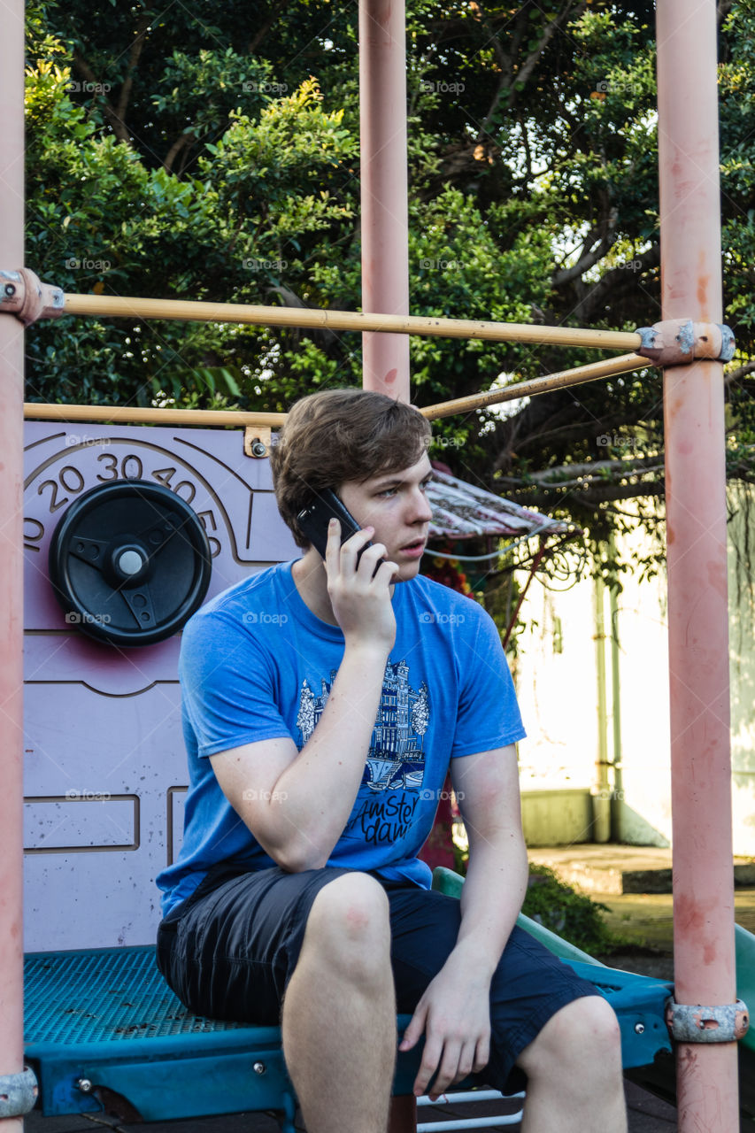 A handsome teenager talking on the phone