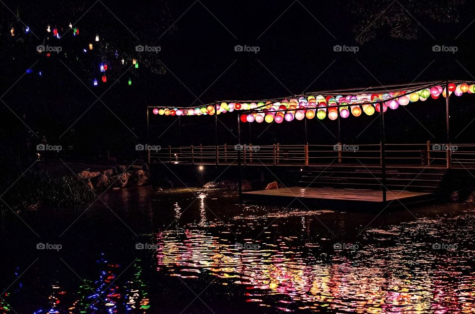 The light from the night lamp reflects on the river