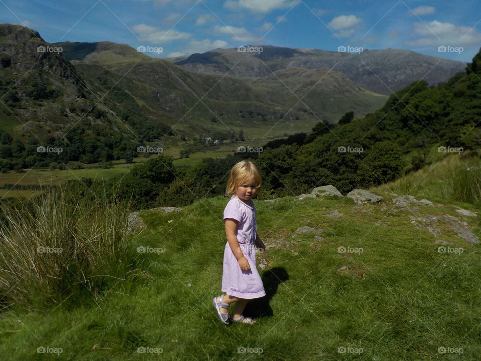 Little girl walking in grass